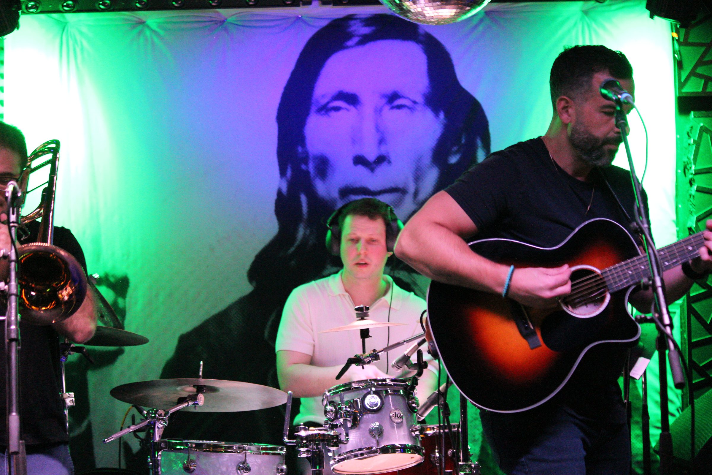 GRANT the band on stage at the Stephen Talkhouse under green light